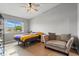 Comfortable bedroom with a ceiling fan, a window with a view, and a loveseat at 135 Orchid Dr, Davenport, FL 33897