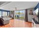 Cozy living room with sliding glass doors leading to a private outdoor area and plenty of natural light at 135 Orchid Dr, Davenport, FL 33897