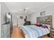 This main bedroom features a ceiling fan, walk-in closet, TV and charming decor at 135 Orchid Dr, Davenport, FL 33897