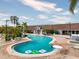 Large in-ground pool with a view of the clubhouse, lounge chairs and a jacuzzi at 135 Orchid Dr, Davenport, FL 33897