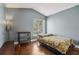 Cozy bedroom with hardwood floors, vaulted ceilings, and bright window view at 143 Abbey Hollow Dr, Apopka, FL 32712