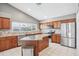 Modern kitchen featuring stainless steel appliances, granite countertops, and a center island at 143 Abbey Hollow Dr, Apopka, FL 32712