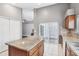 Spacious kitchen island with granite countertops, white tile floors, and stainless steel dishwasher at 143 Abbey Hollow Dr, Apopka, FL 32712
