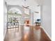 Bright living room with vaulted ceilings, wood floors, and a large window with plant decor at 143 Abbey Hollow Dr, Apopka, FL 32712
