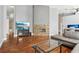Stylish living room with a stone fireplace, hardwood floors, and a large flatscreen TV at 143 Abbey Hollow Dr, Apopka, FL 32712