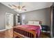 Comfortable bedroom featuring hardwood floors, a ceiling fan, and neutral gray walls at 143 Abbey Hollow Dr, Apopka, FL 32712
