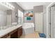 Bathroom featuring a large bathtub, separate shower, and ample counter space at 14537 Cheever St, Orlando, FL 32828