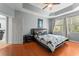 Bedroom with wooden floors, tray ceiling, and natural light from the window at 14537 Cheever St, Orlando, FL 32828
