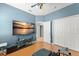 Spacious bedroom with a colorful ceiling fan, TV, and ample closet space at 14537 Cheever St, Orlando, FL 32828