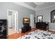 Bedroom with wooden floors, tray ceiling, and an attached bathroom at 14537 Cheever St, Orlando, FL 32828