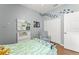 Bright bedroom featuring wood floors, closet, and comfy armchair at 14537 Cheever St, Orlando, FL 32828