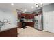 Kitchen featuring stainless steel appliances, dark wood cabinets, and tiled floors at 14537 Cheever St, Orlando, FL 32828