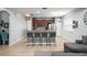 Kitchen with a breakfast bar, dark wood cabinets, stainless steel appliances, and an open layout to the living area at 14537 Cheever St, Orlando, FL 32828