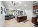 Open layout featuring a kitchen with a breakfast bar, stainless steel appliances, tile flooring, and living area at 14537 Cheever St, Orlando, FL 32828