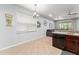 Bright kitchen with stainless steel dishwasher, granite countertops, and tile flooring at 14537 Cheever St, Orlando, FL 32828