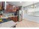 Bright kitchen with stainless steel refrigerator, dark wood cabinets, and tile flooring at 14537 Cheever St, Orlando, FL 32828