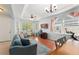 Bright and airy living room with large windows, wood floors, a ceiling fan, and a cozy seating area at 14537 Cheever St, Orlando, FL 32828