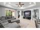 Spacious living room with a large grey sectional sofa and a view of the screened lanai at 14537 Cheever St, Orlando, FL 32828