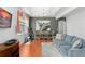 Open-concept living and dining area with wood floors, modern lighting, and a comfortable blue sofa at 14537 Cheever St, Orlando, FL 32828