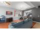 Living and dining area with wood floors, large windows, modern lighting, neutral walls, and a cozy blue couch at 14537 Cheever St, Orlando, FL 32828