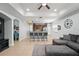 Open-concept living space with a kitchen, breakfast bar, tile floors, and a cozy living area with a gray sectional sofa at 14537 Cheever St, Orlando, FL 32828