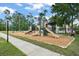 Community playground area with multiple slides, swings, and a soft ground cover for safety at 14537 Cheever St, Orlando, FL 32828