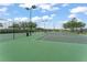 Community tennis courts with lighting and seating area, perfect for social games at 14537 Cheever St, Orlando, FL 32828