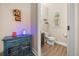 Stylish half bathroom featuring modern fixtures and colorful vintage decor accents at 14742 Bahama Swallow Blvd, Winter Garden, FL 34787