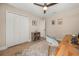 Neutral bedroom featuring hardwood floors, ceiling fan, closet and bright light at 14742 Bahama Swallow Blvd, Winter Garden, FL 34787