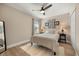 Bedroom features a large bed, hardwood floors, ceiling fan and a view of the window at 14742 Bahama Swallow Blvd, Winter Garden, FL 34787