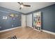 Neutral bedroom with hardwood floors, a ceiling fan and a bookshelf against the wall at 14742 Bahama Swallow Blvd, Winter Garden, FL 34787