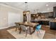 Charming dining area with farmhouse-style table, modern lighting, and easy access to the kitchen at 14742 Bahama Swallow Blvd, Winter Garden, FL 34787