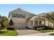 Charming two-story home with a two-car garage, a manicured lawn, and well-maintained landscaping at 14742 Bahama Swallow Blvd, Winter Garden, FL 34787