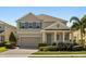Charming two-story home with a manicured lawn and inviting brick driveway on a sunny day at 14742 Bahama Swallow Blvd, Winter Garden, FL 34787