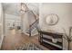 Inviting foyer with hardwood floors, staircase, decor table and decor with a view to the living area at 14742 Bahama Swallow Blvd, Winter Garden, FL 34787