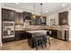 Stylish kitchen equipped with an island, stainless steel appliances, granite counters, and dark cabinetry at 14742 Bahama Swallow Blvd, Winter Garden, FL 34787