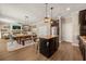Open kitchen with island, stainless appliances, pendant lighting, and seamless access to the living and dining areas at 14742 Bahama Swallow Blvd, Winter Garden, FL 34787