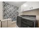 Laundry room with washer and dryer hookups and modern wallpaper at 14742 Bahama Swallow Blvd, Winter Garden, FL 34787