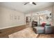 Open-concept living room with hardwood floors and neutral paint, flowing seamlessly into the dining and kitchen areas at 14742 Bahama Swallow Blvd, Winter Garden, FL 34787