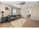 Cozy living room includes a grey sofa, hardwood floors and neutral walls at 14742 Bahama Swallow Blvd, Winter Garden, FL 34787