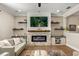 Inviting living room features a modern electric fireplace, a mounted TV, and floating shelves for stylish storage at 14742 Bahama Swallow Blvd, Winter Garden, FL 34787