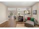 Comfortable living room with hardwood floors with a view to the dining room and backyard at 14742 Bahama Swallow Blvd, Winter Garden, FL 34787