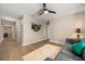 Spacious living room with hardwood floors, a mounted TV, neutral walls, and grey sofa at 14742 Bahama Swallow Blvd, Winter Garden, FL 34787