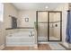 Bright bathroom features a glass shower, soaking tub, and neutral paint at 14742 Bahama Swallow Blvd, Winter Garden, FL 34787