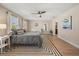 Bright main bedroom with a ceiling fan, large windows and ensuite bathroom at 14742 Bahama Swallow Blvd, Winter Garden, FL 34787