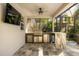 Well-equipped outdoor kitchen with stainless steel grill, granite counters, and bar seating under a covered lanai at 14742 Bahama Swallow Blvd, Winter Garden, FL 34787