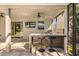 Covered outdoor kitchen features a built-in grill, bar seating, ceiling fan and a convenient serving area at 14742 Bahama Swallow Blvd, Winter Garden, FL 34787