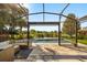 Relaxing screened-in lanai with wicker seating, view of the sparkling pool, and landscaped backyard at 14742 Bahama Swallow Blvd, Winter Garden, FL 34787