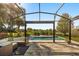 Relaxing screened-in lanai with wicker seating, view of the sparkling pool, and landscaped backyard at 14742 Bahama Swallow Blvd, Winter Garden, FL 34787