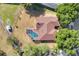 Aerial view of a house with brown roof, screened-in pool and a small storage shed at 1512 Adriatic Dr, Ocoee, FL 34761